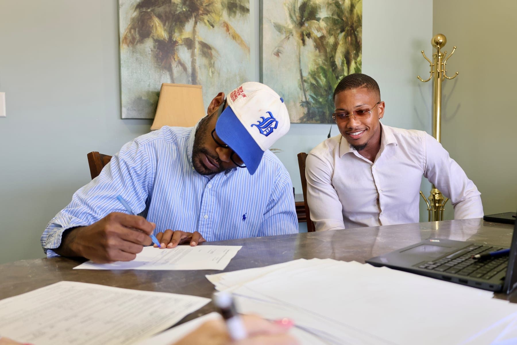 Don Narcisse walking a client through closing paperwork